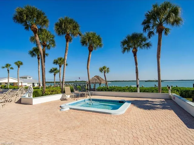 View of swimming pool featuring a water view and a patio area