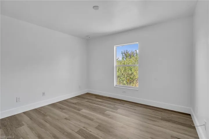Spare room featuring light wood-style flooring