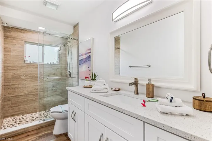 Full bathroom featuring vanity and a shower stall