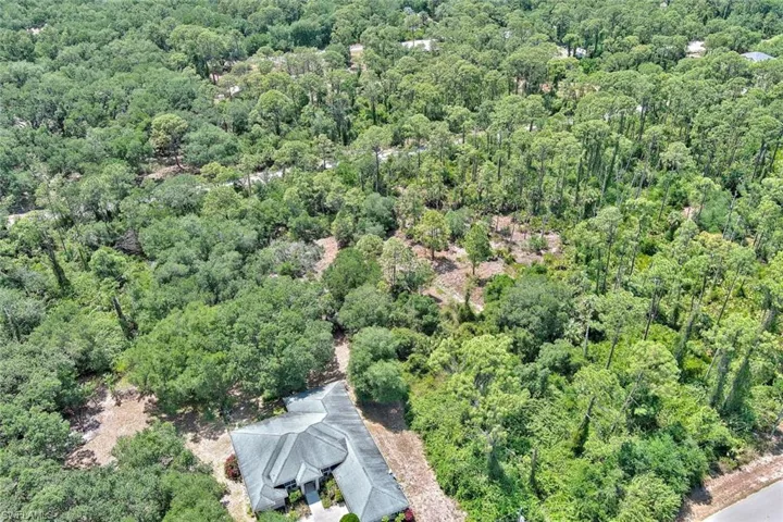 View of property location featuring a heavily wooded area