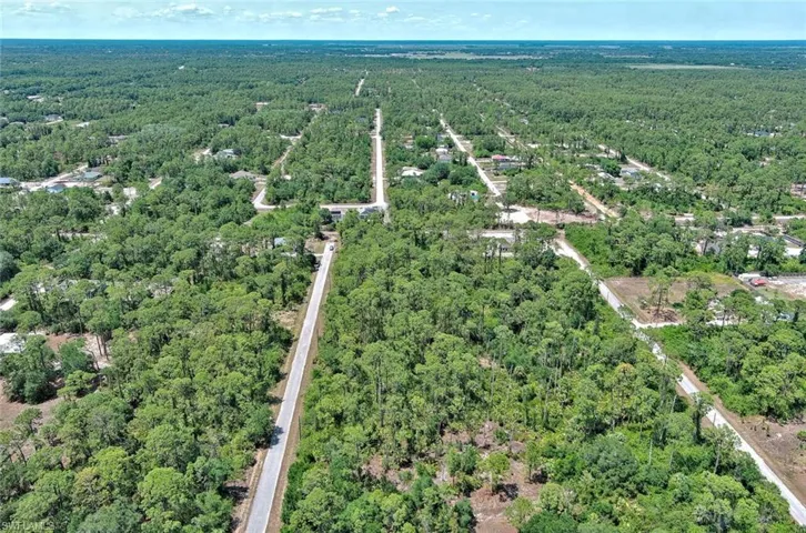 Aerial view of property's location with a forest
