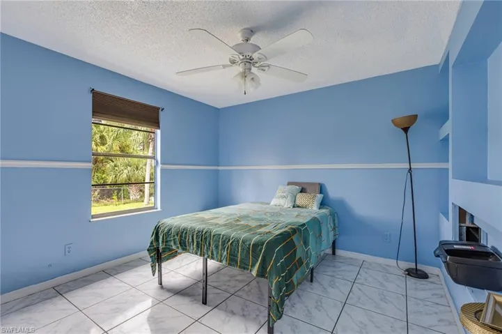 Bedroom featuring a textured ceiling and a ceiling fan