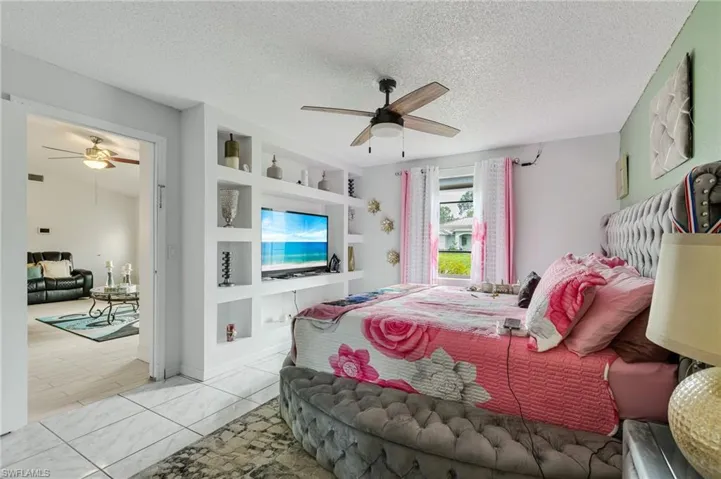 Bedroom featuring a textured ceiling and ceiling fan
