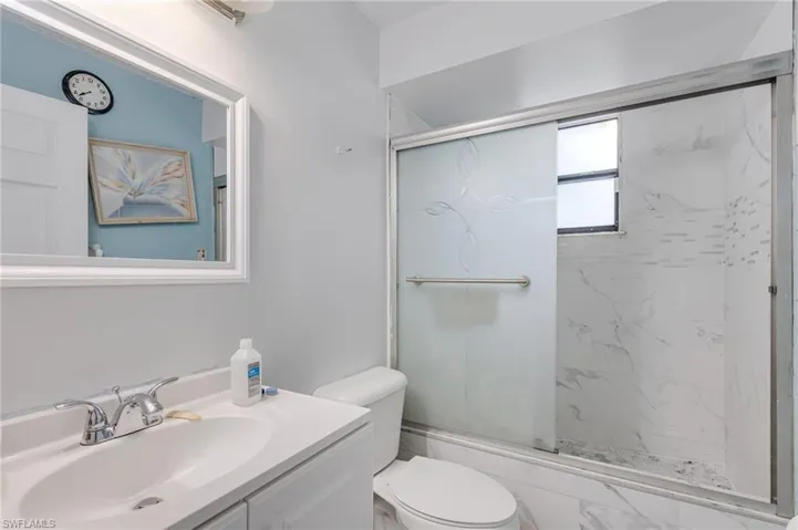 Full bathroom with vanity and a marble finish shower