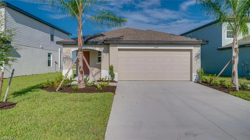 View of front of home featuring a garage and a front lawn