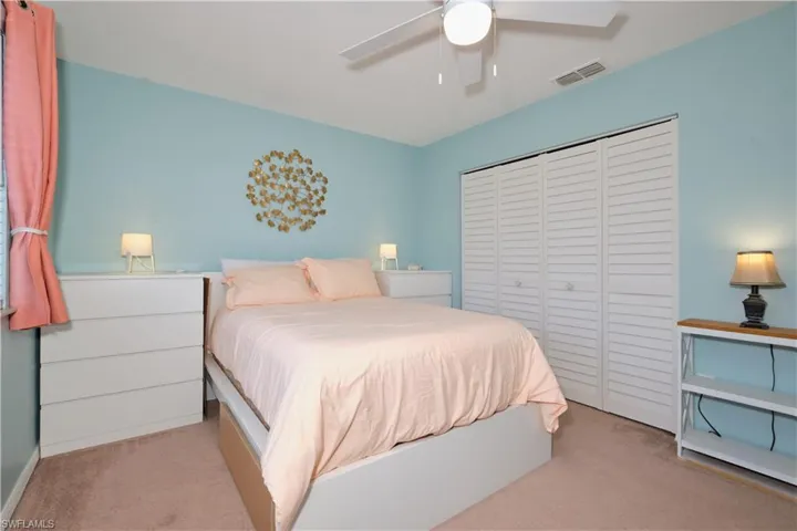 Bedroom featuring carpet floors, a closet, and ceiling fan