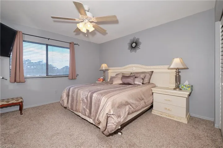 Bedroom featuring light colored carpet and ceiling fan