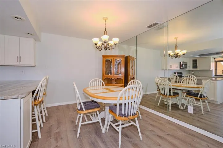 Dining room featuring hanging lights and light wood finished floors