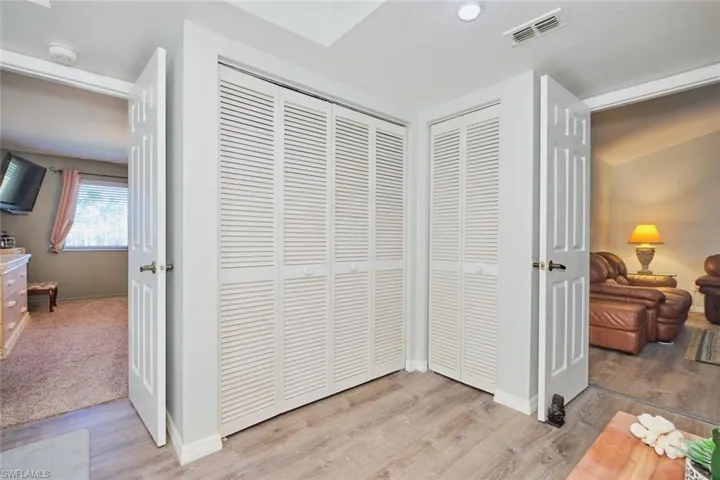 Detailed view of wood finished floors and a smoke detector