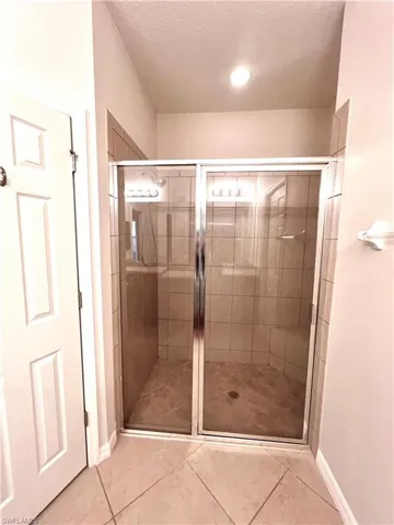 Bathroom Features Tiled Walk In Shower With Built In Bench and Private Water Closet