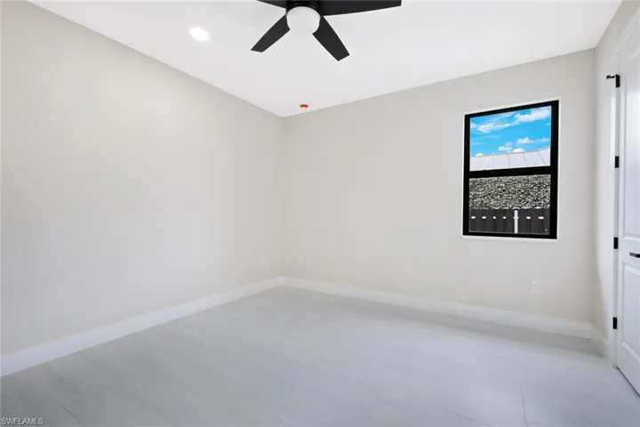 Unfurnished room with baseboards and a ceiling fan