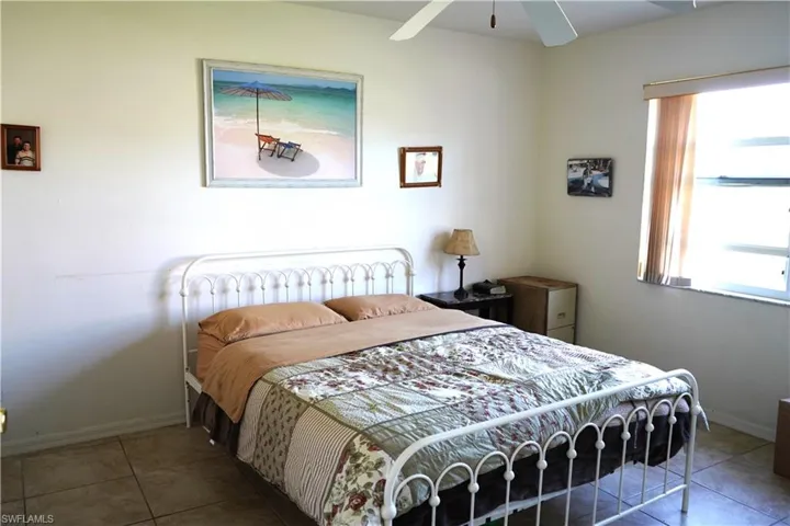 Tiled bedroom with ceiling fan