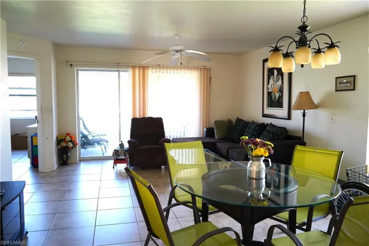 Tiled dining room with ceiling fan