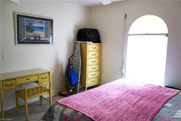 Bedroom featuring tile floors and ceiling fan