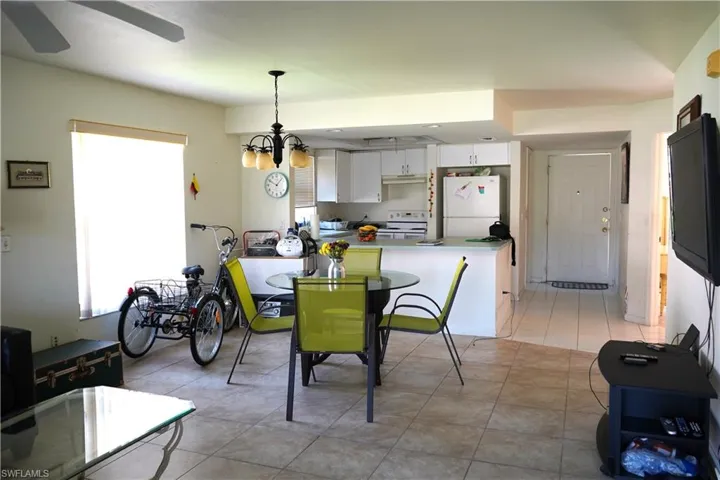 Tiled dining space featuring ceiling fan
