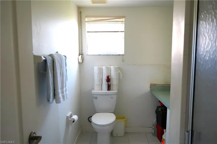 Bathroom featuring tile floors and toilet