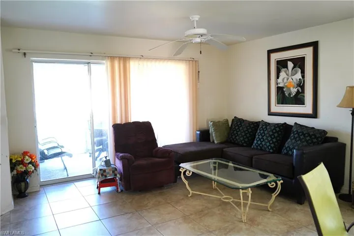 Tiled living room featuring ceiling fan and a healthy amount of sunlight