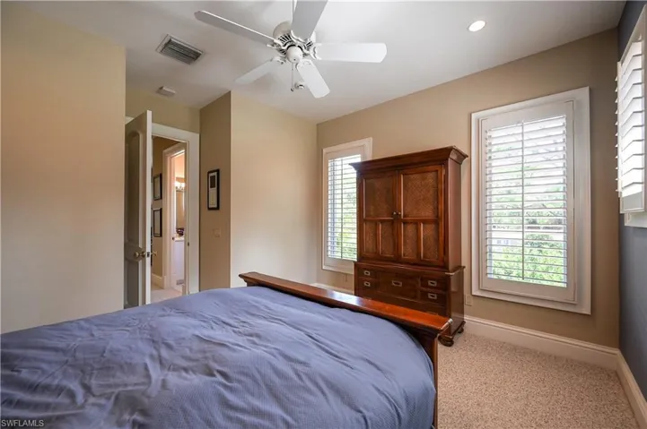 Guest apartment Bedroom with light carpet and a ceiling fan