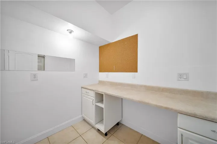 Unfurnished office featuring light tile patterned floors and baseboards