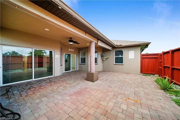 View of patio with a fenced backyard and ceiling fan
