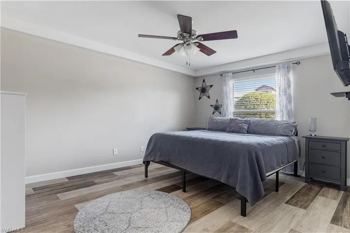 Bedroom featuring hardwood / wood-style floors and ceiling fan