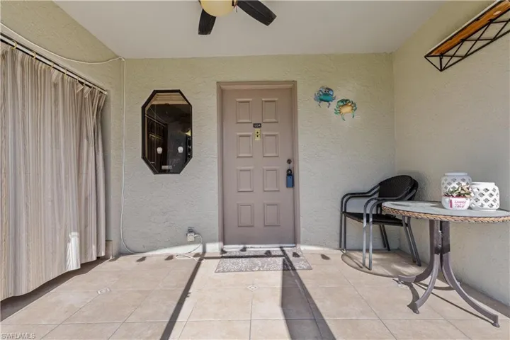 Entrance to property featuring ceiling fan