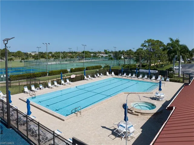 View of pool featuring a patio and a hot tub