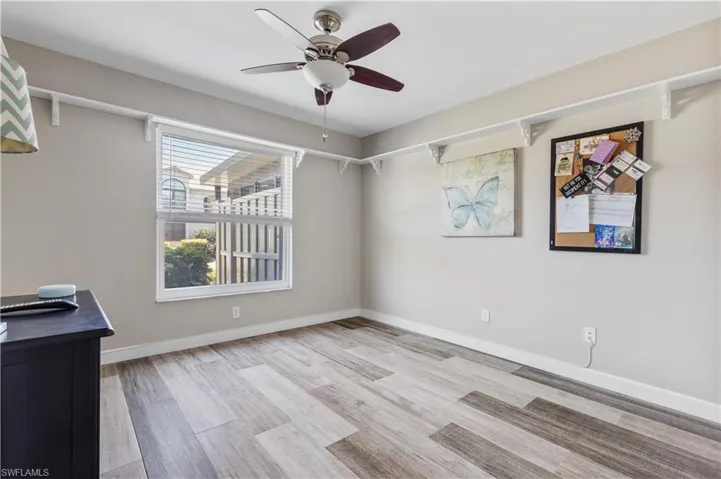 Empty room with light wood-type flooring and ceiling fan