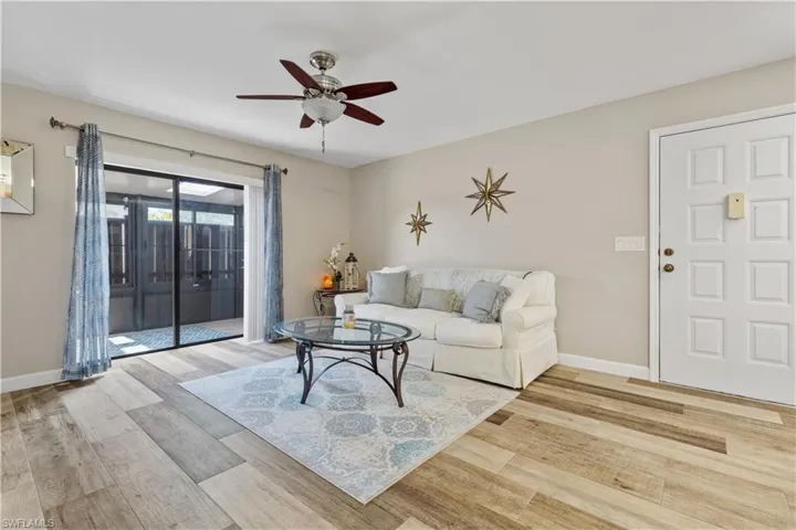 Living room featuring ceiling fan and wood-type flooring