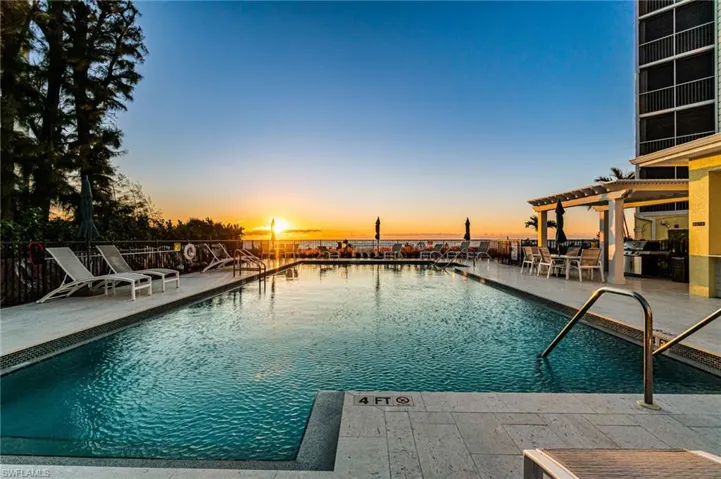 Picturesque redesigned beachfront pool area featuring an extended sun deck, cabanas, and grilling area.