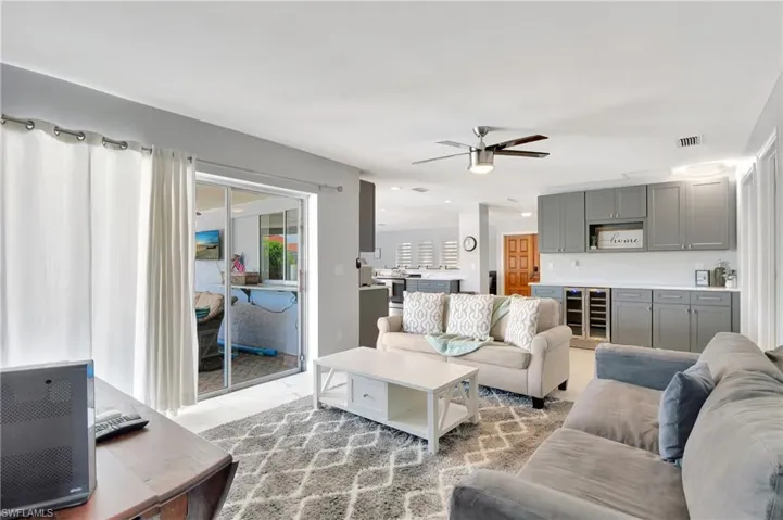 Living room featuring beverage cooler and ceiling fan