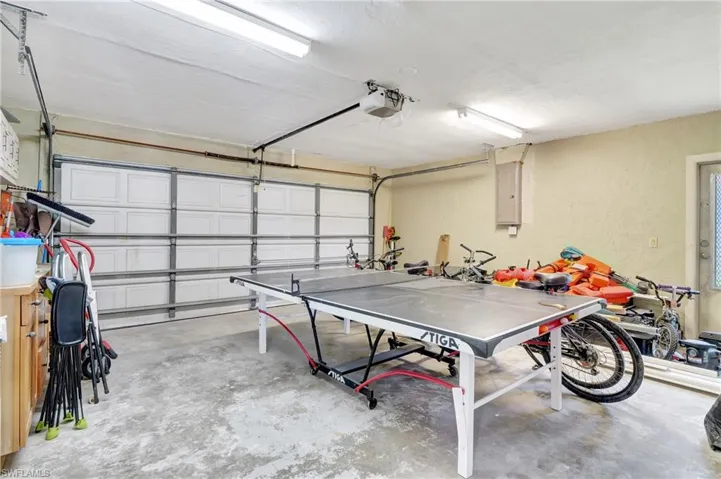 Garage featuring electric panel and a garage door opener