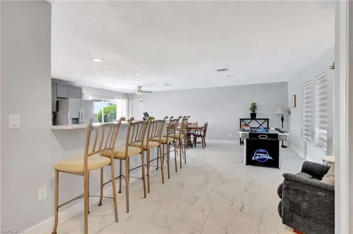 Dining room with light tile patterned floors and ceiling fan