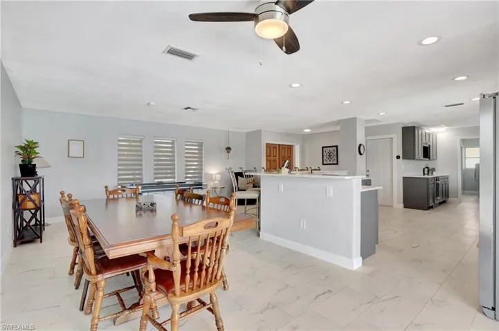 Tiled dining room with ceiling fan