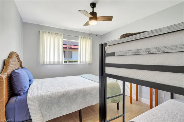 Tiled bedroom with ceiling fan