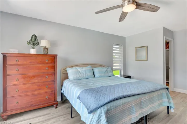 Bedroom with light hardwood / wood-style floors and ceiling fan