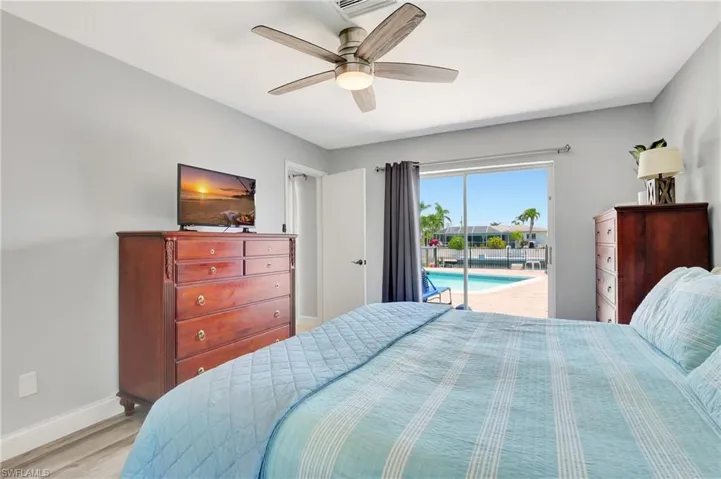 Bedroom featuring light hardwood / wood-style floors, access to outside, and ceiling fan
