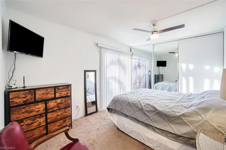 Bedroom with carpet flooring, a ceiling fan, and a closet