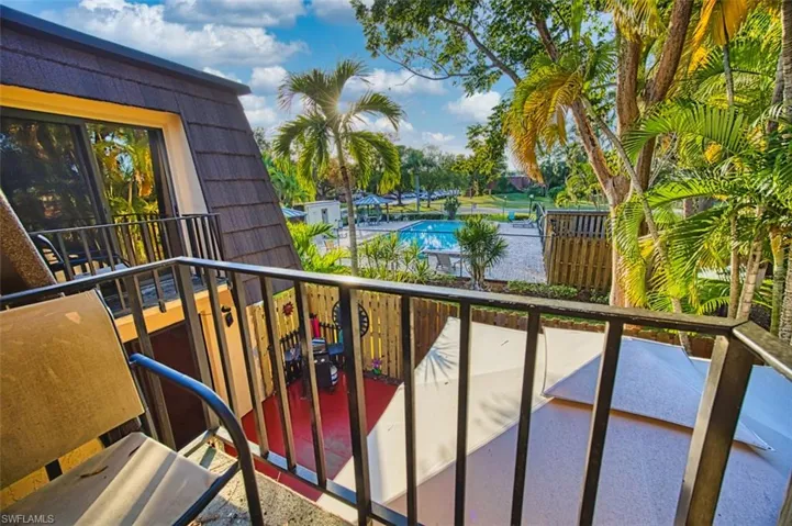 Balcony featuring view of pool area