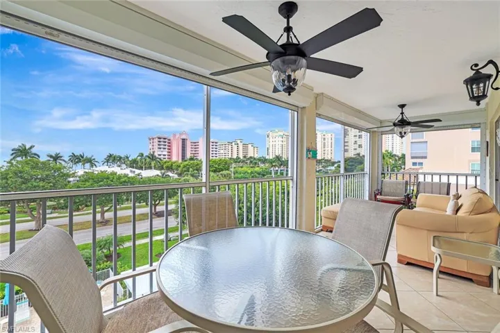 Sunroom / solarium featuring tile patterned floors, plenty of natural light, and a view of city