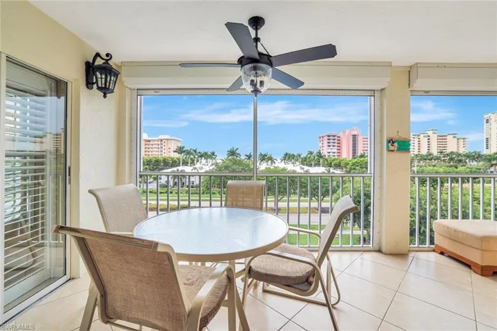 Sunroom featuring tile patterned floors and a city view