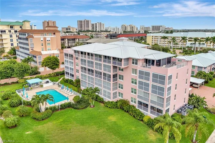 View of urban area featuring a pool and apartment complex / building