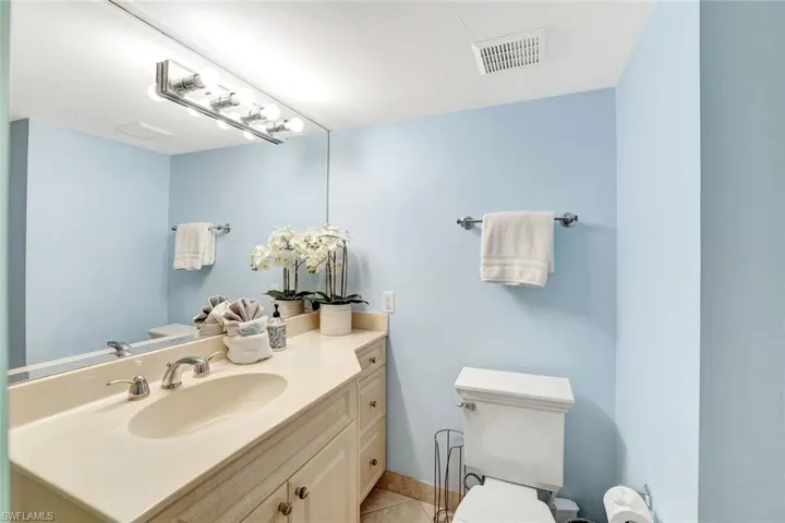Half bathroom featuring vanity and light tile patterned floors