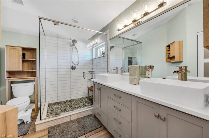 Remodeled primary bath with glass shower