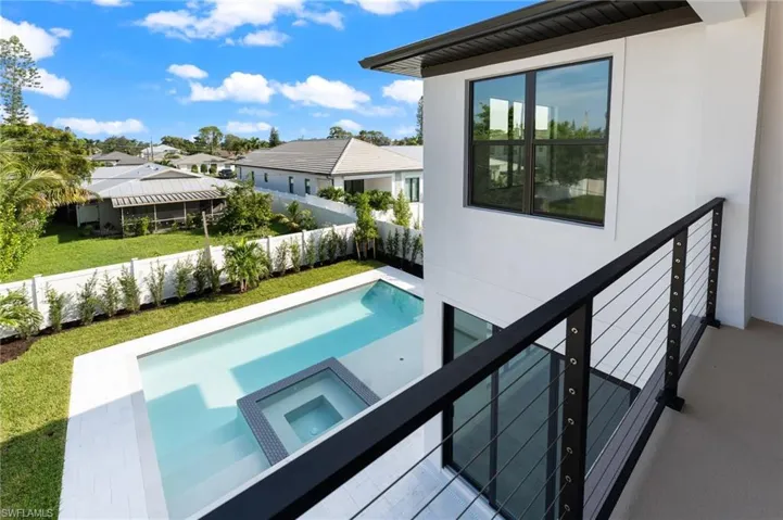 View of pool with an in ground pool and spa from the upstairs terrace off the Bonus Room