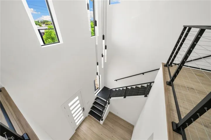 Staircase featuring hardwood / wood-style floors