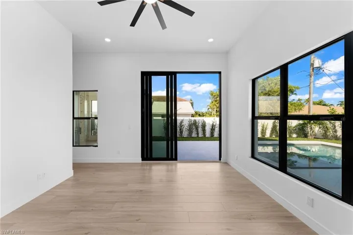 Primary Bedroom with12' ceilings in your  suite with backyard pool views
