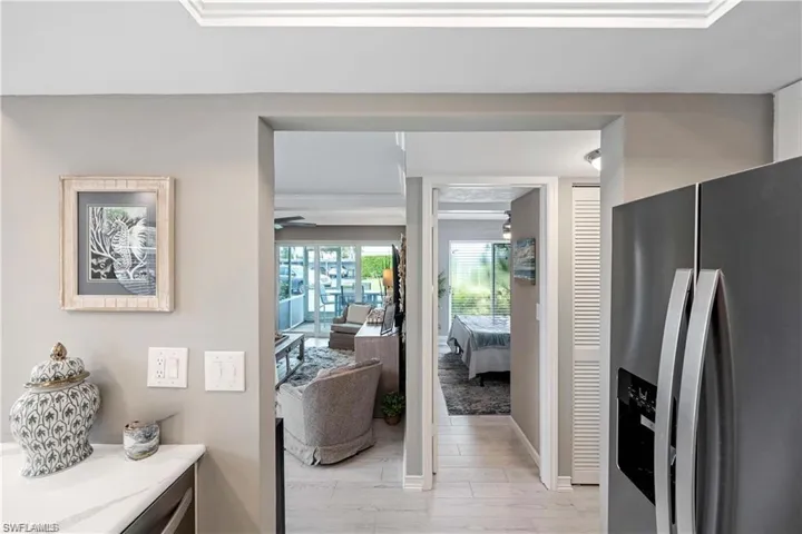 Interior view highlighting the open layout connecting the kitchen, living area, and bedroom hallway.