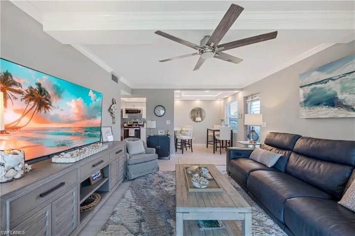 Bright open living area with coastal-inspired finishes and an easy flow to the dining space and kitchen