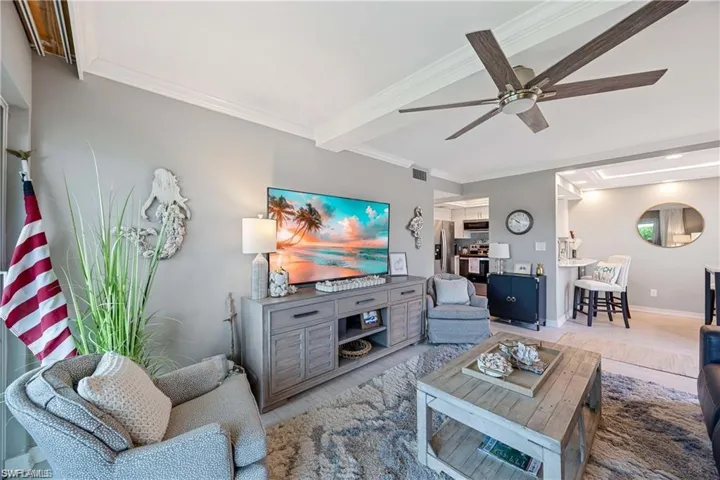 Bright kitchen with white cabinetry, stainless steel appliances, quartz-style countertops, and recessed lighting.